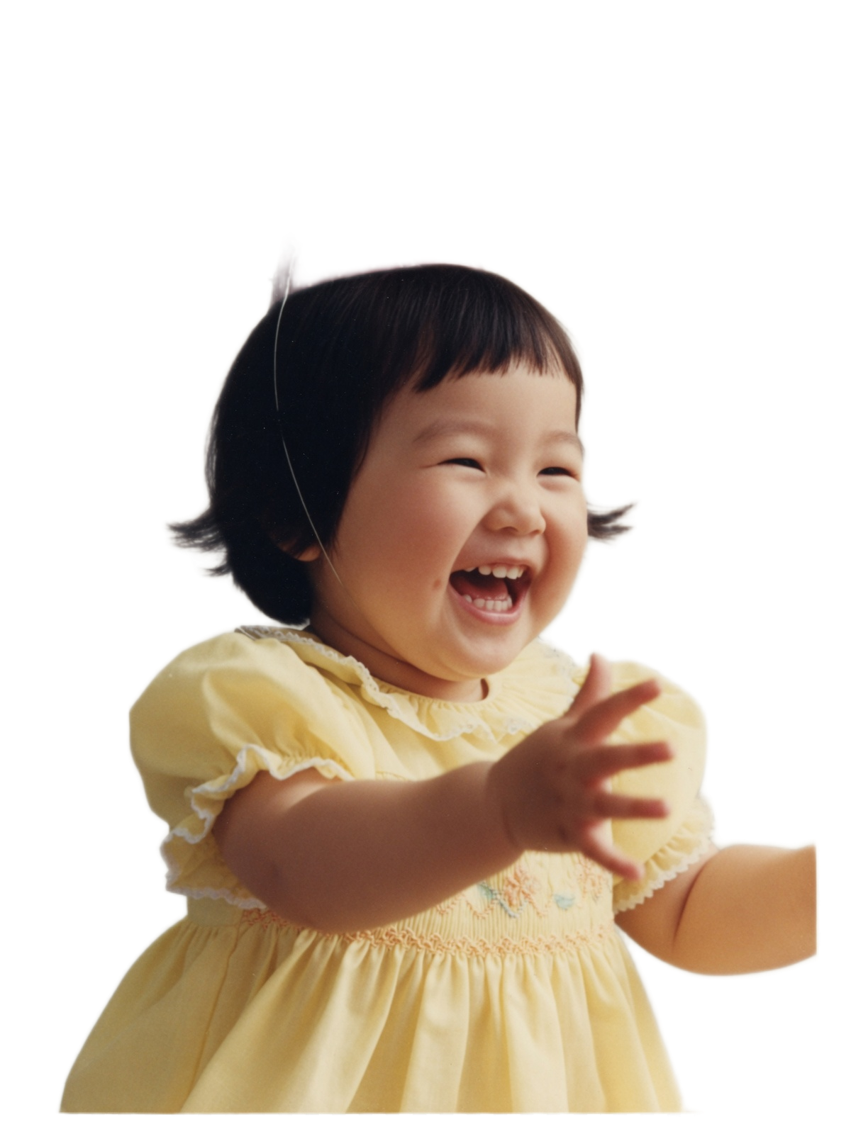 A smiling little girl in a birthday hat
